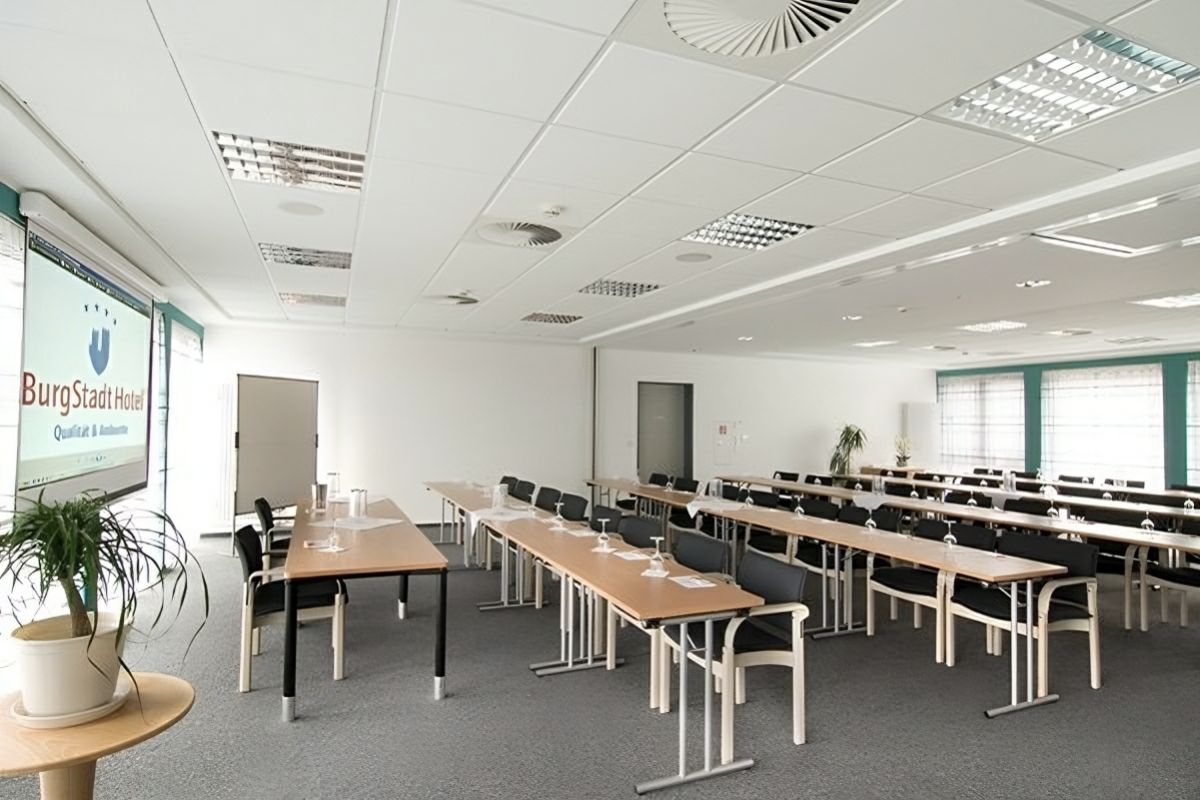 Seminarraum des Burgstadt Hotels Kastellaun mit Tischen und Stühlen.